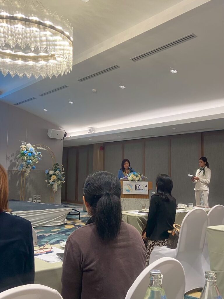 Attendees and organizers gathered at the opening of the Thailand Green Premium Spark 2026 seminar, with a floral arch on stage