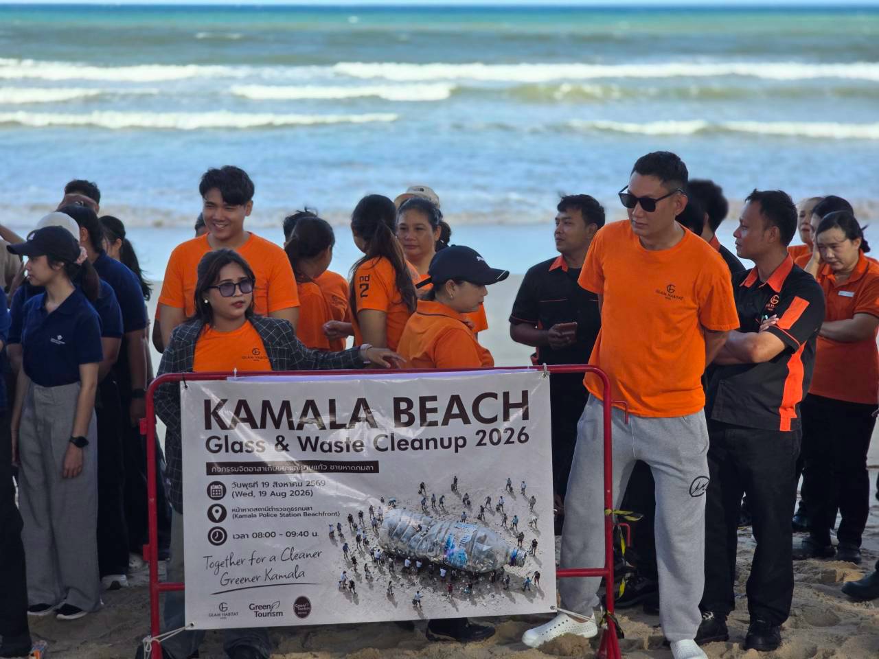 Volunteers from Glam Habitat, The Marin Phuket, Keemala, Sunwing Kamala Beach, Wyndham Garden Phuket Kamala and Kamala Police Station gather on Kamala Beach for the group photo
