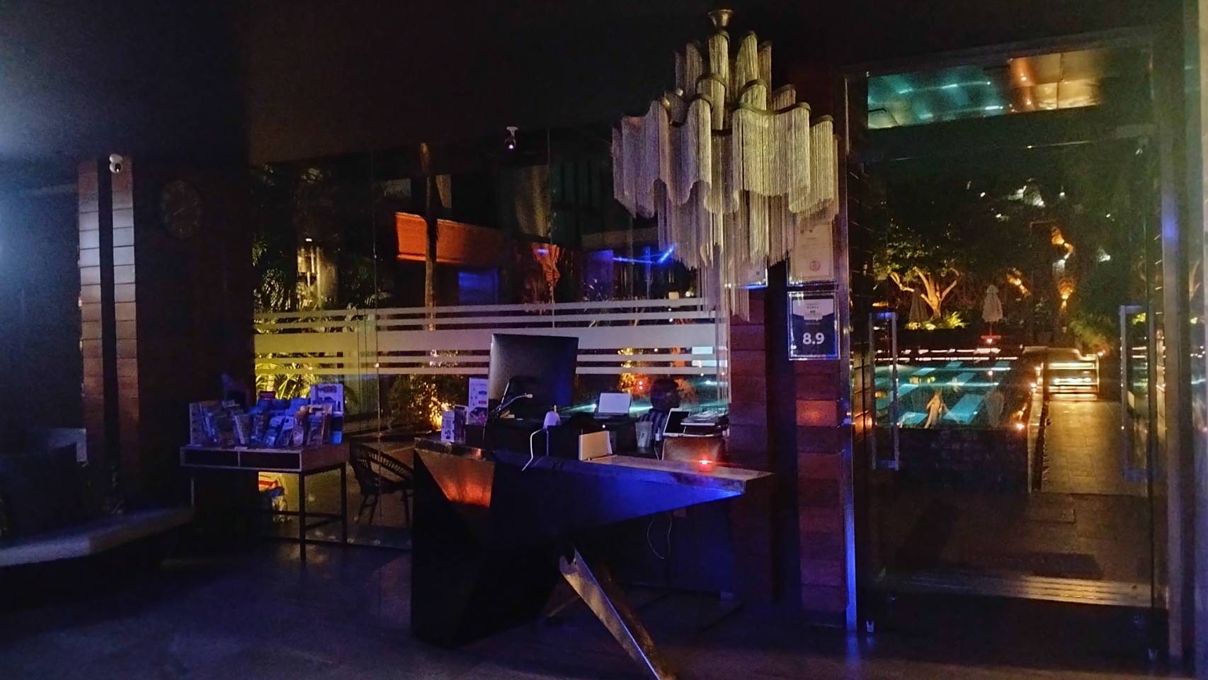 The Glam Habitat Hotel reception area lit by ambient lighting alone during Earth Hour 2025
