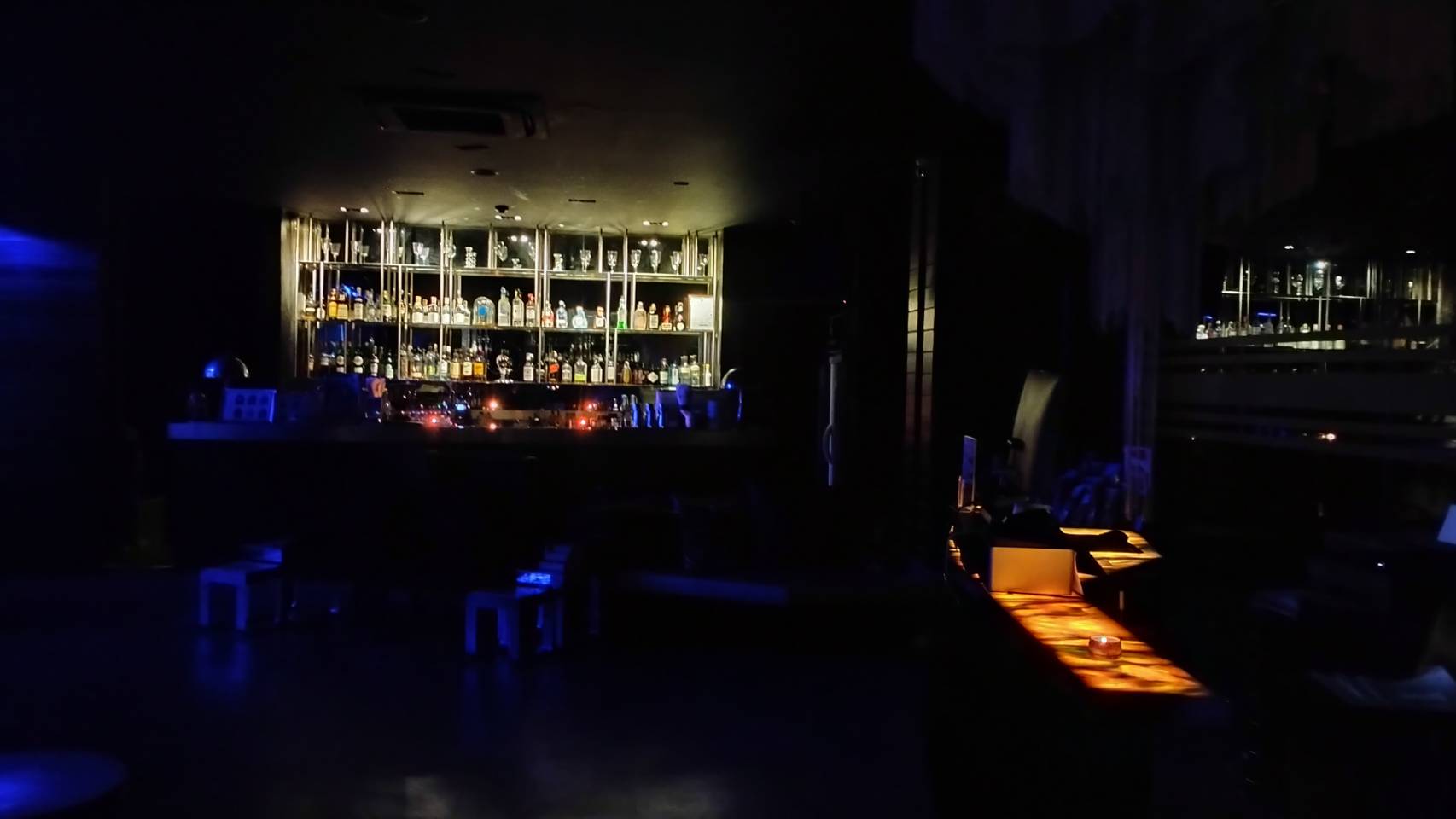 The hotel bar illuminated only by candlelight during Earth Hour 2025 at Glam Habitat Hotel