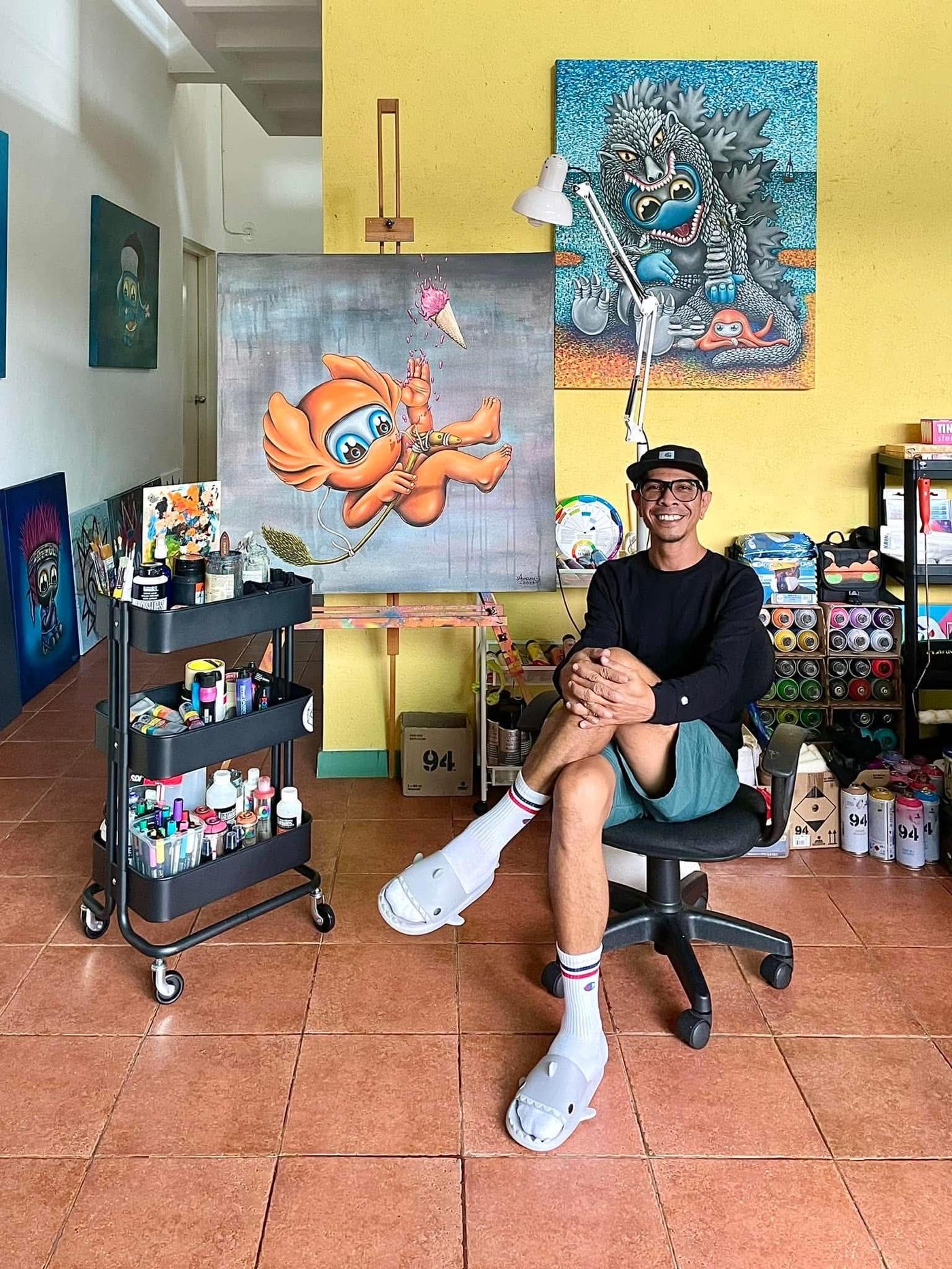 Amann in his studio in Phuket, surrounded by paintings from the Mute series