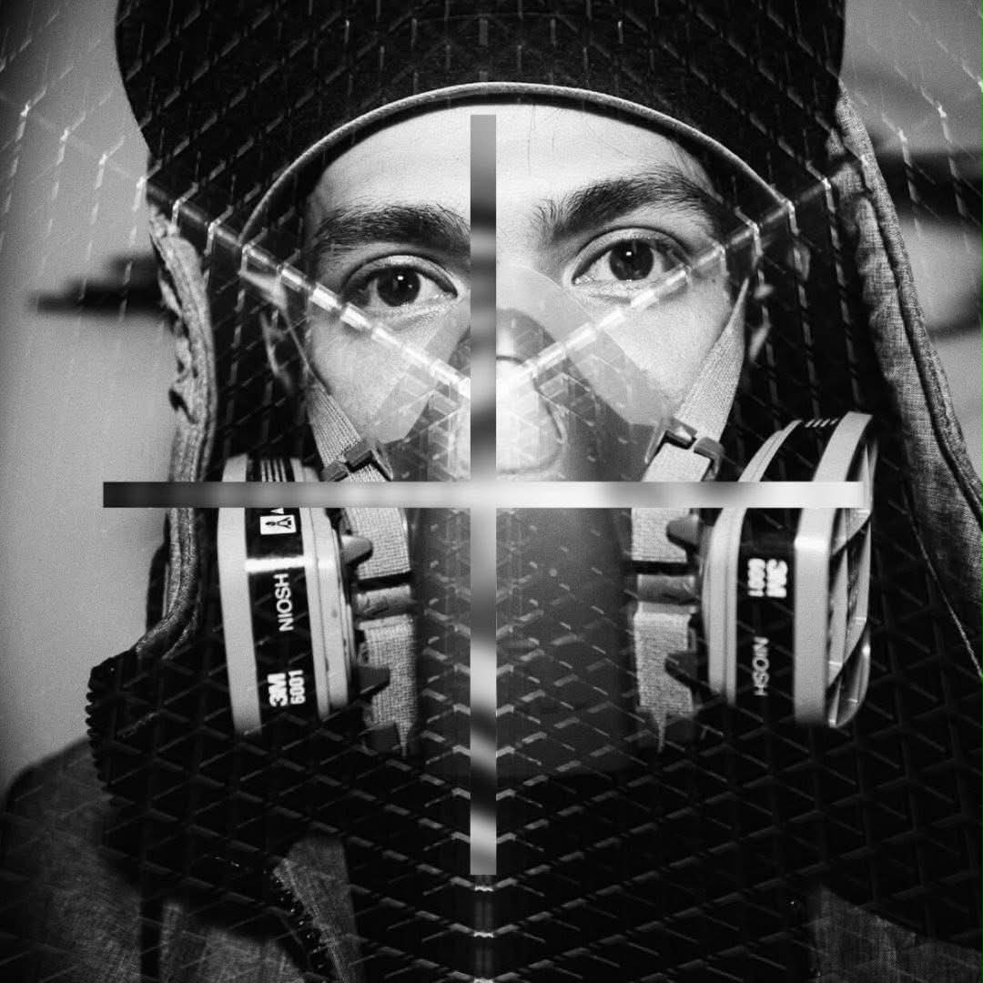 Portrait of Thai artist Amann wearing a respirator mask, double-exposure style
