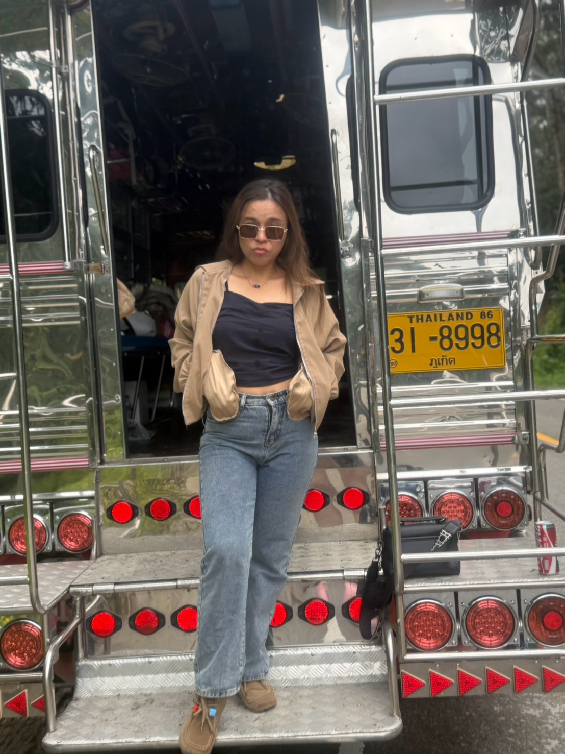 A Glam Habitat team member posing at the back of the decorated party truck used for Outing 2026