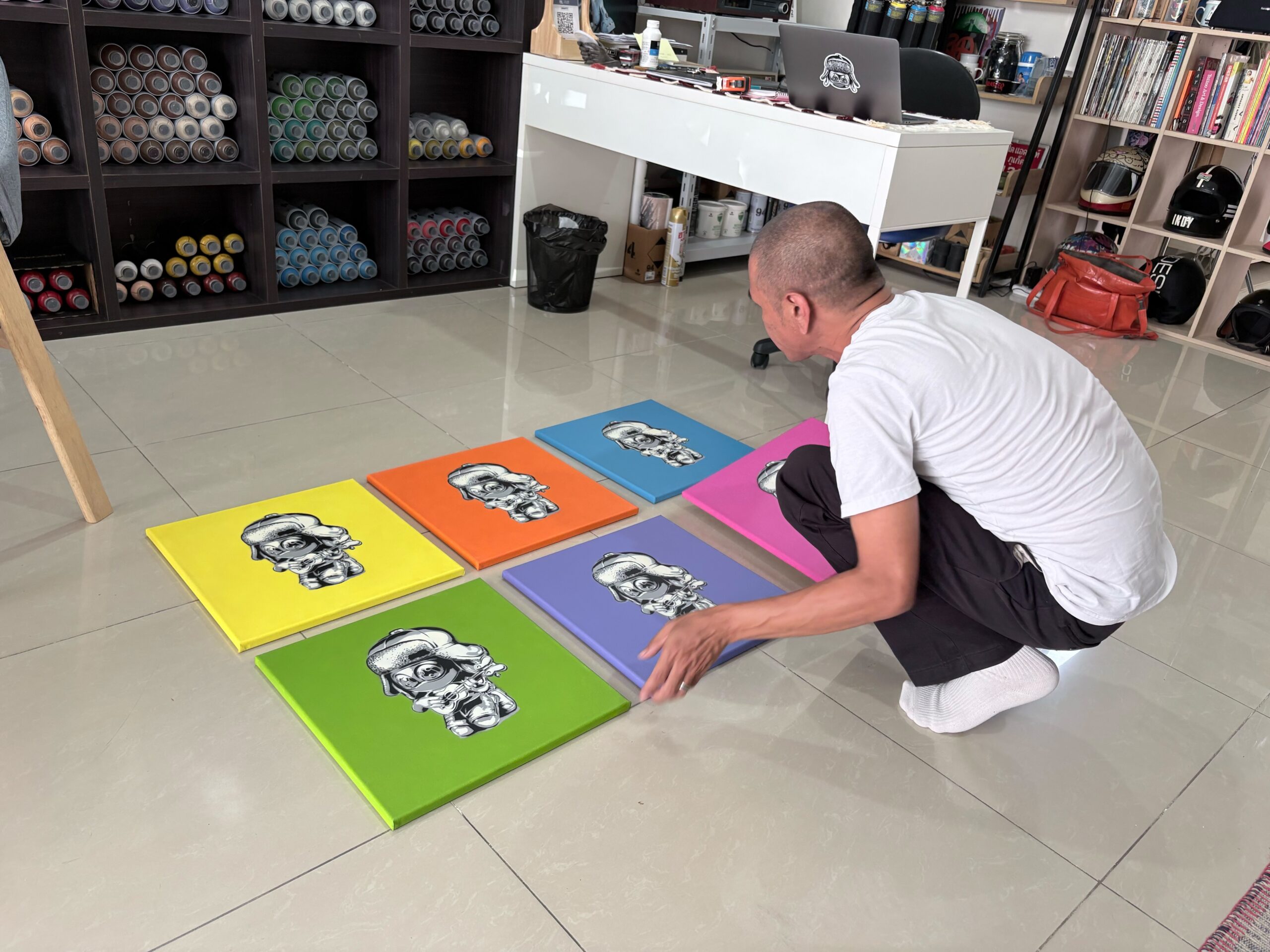 Six colourway canvases from Amann's Mute is Future, Pop Series arranged on the studio floor