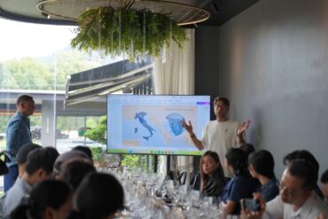 A Villa Saletta presenter explaining the estate's location in Tuscany on a map of Italy during the wine masterclass