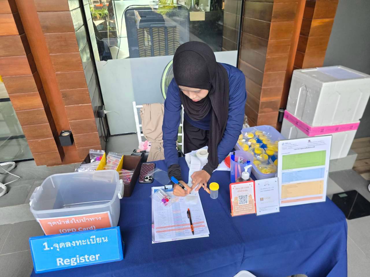 The registration table for the Glam Habitat annual staff health check, with forms and sample containers ready