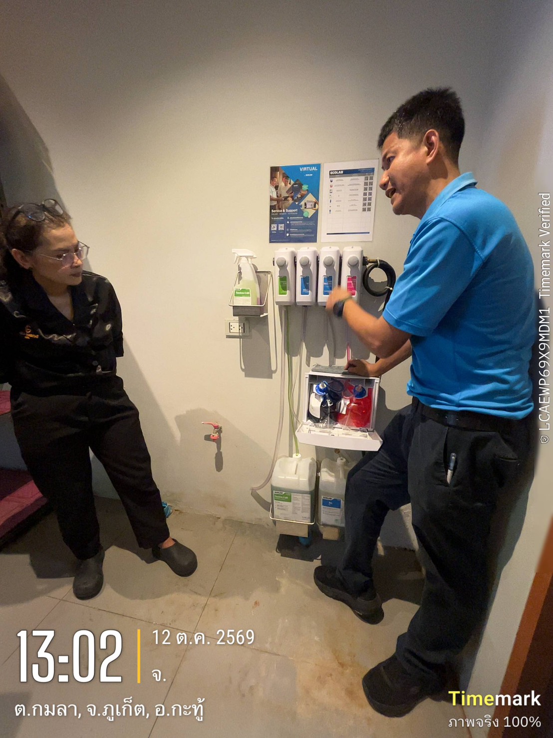 An ECOLAB technician explaining the new four-product dilution station to a Glam Habitat housekeeping supervisor
