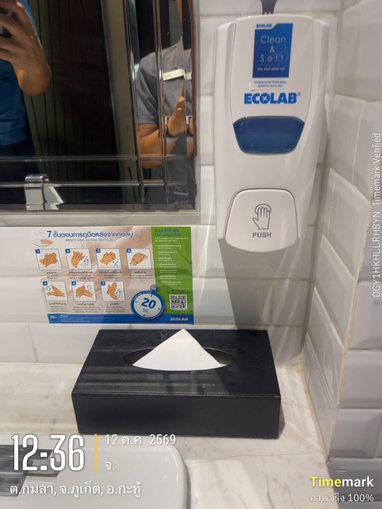 An ECOLAB Clean & Soft antibacterial hand soap dispenser and seven-step hand washing poster installed in a Glam Habitat Hotel restroom