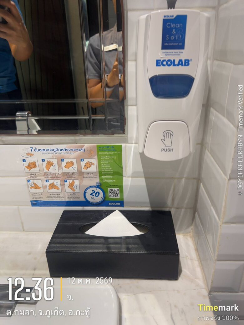 An ECOLAB Clean & Soft antibacterial hand soap dispenser and seven-step hand washing poster installed in a Glam Habitat Hotel restroom