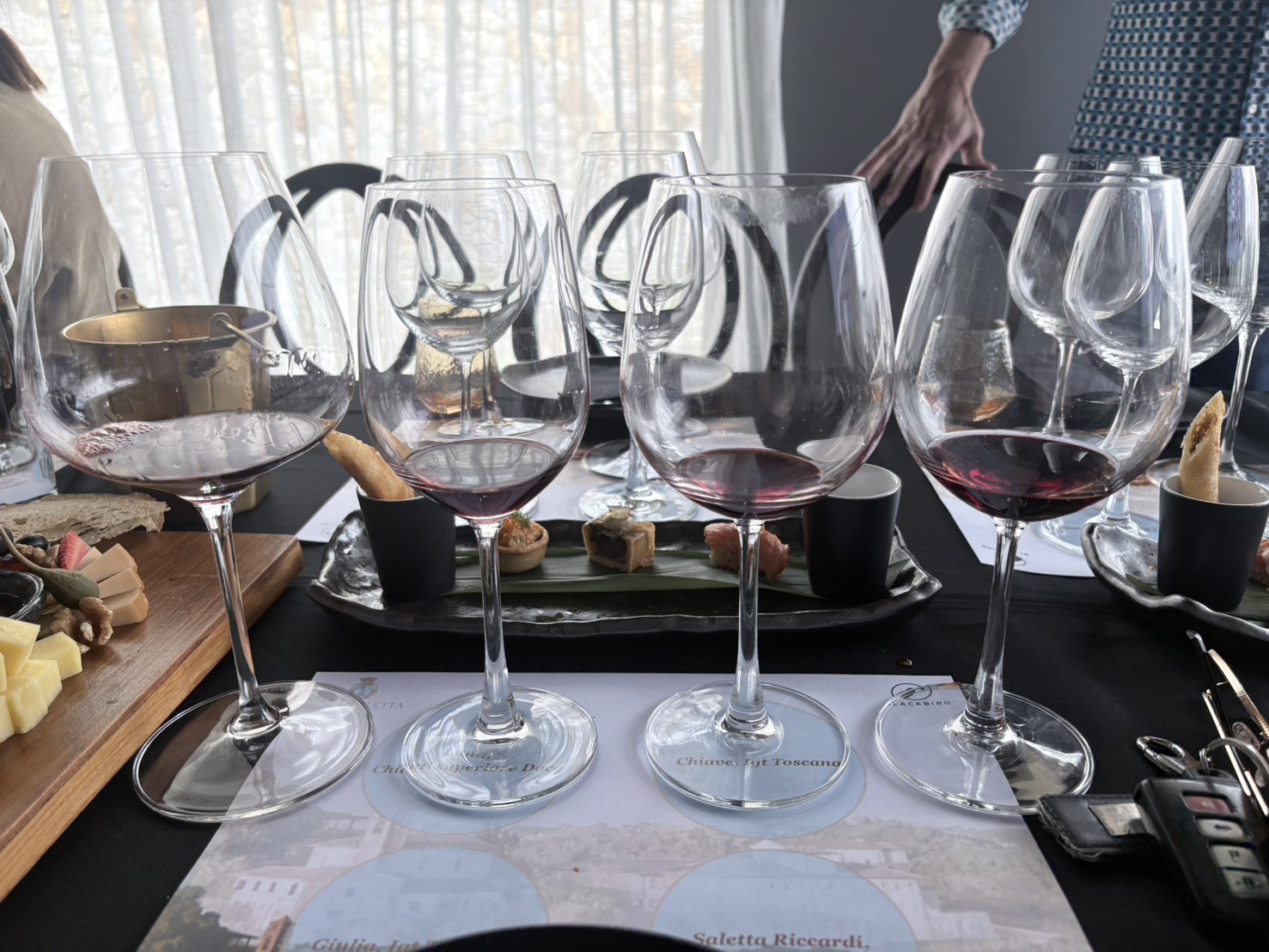 Four Villa Saletta red wines poured on a tasting mat, from Luna Chianti Superiore to Chiave IGT Toscana