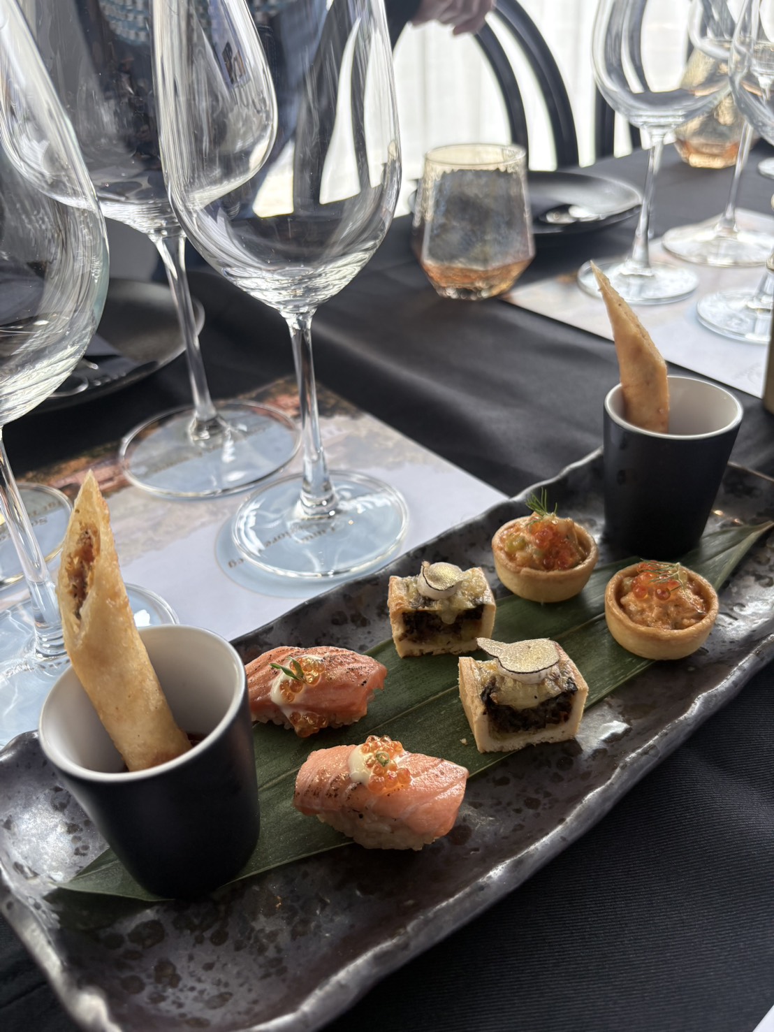 Canapés of seared salmon nigiri, truffle tartlets and crispy rolls served at the wine masterclass